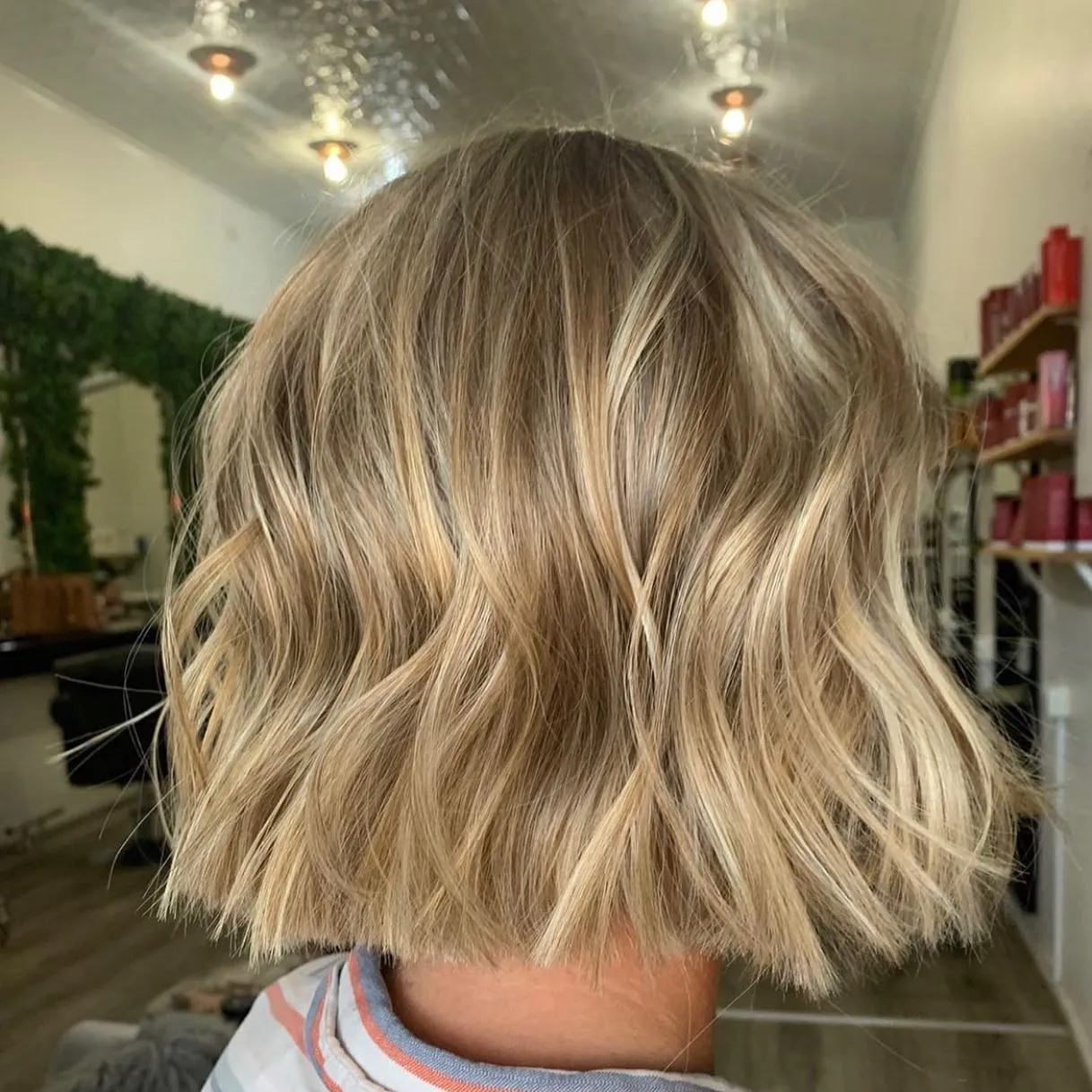 Textured blonde bob cut and styled with soft waves at Runway Tamworth