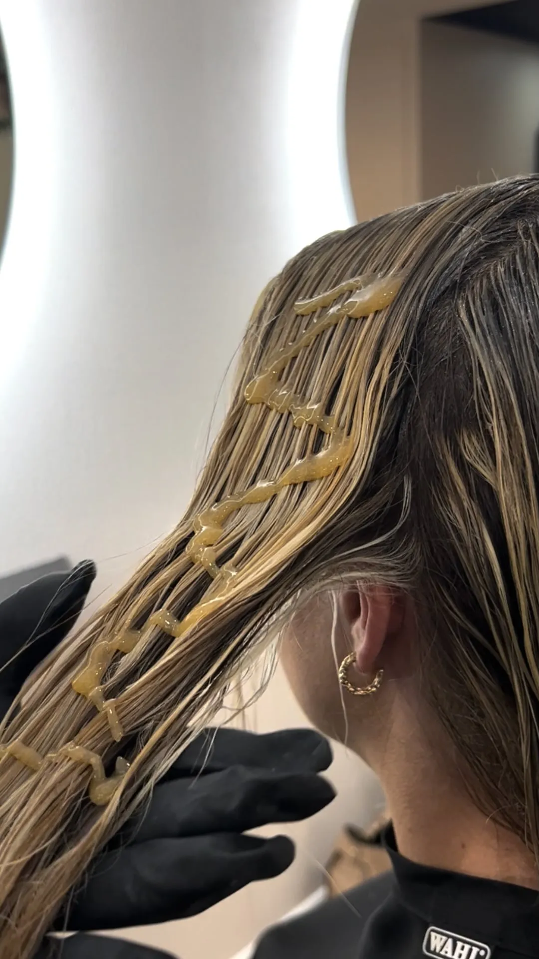 Keratin bond extensions being applied strand by strand at Runway Tamworth
